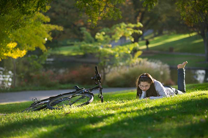 girl reading book at the Arboretum