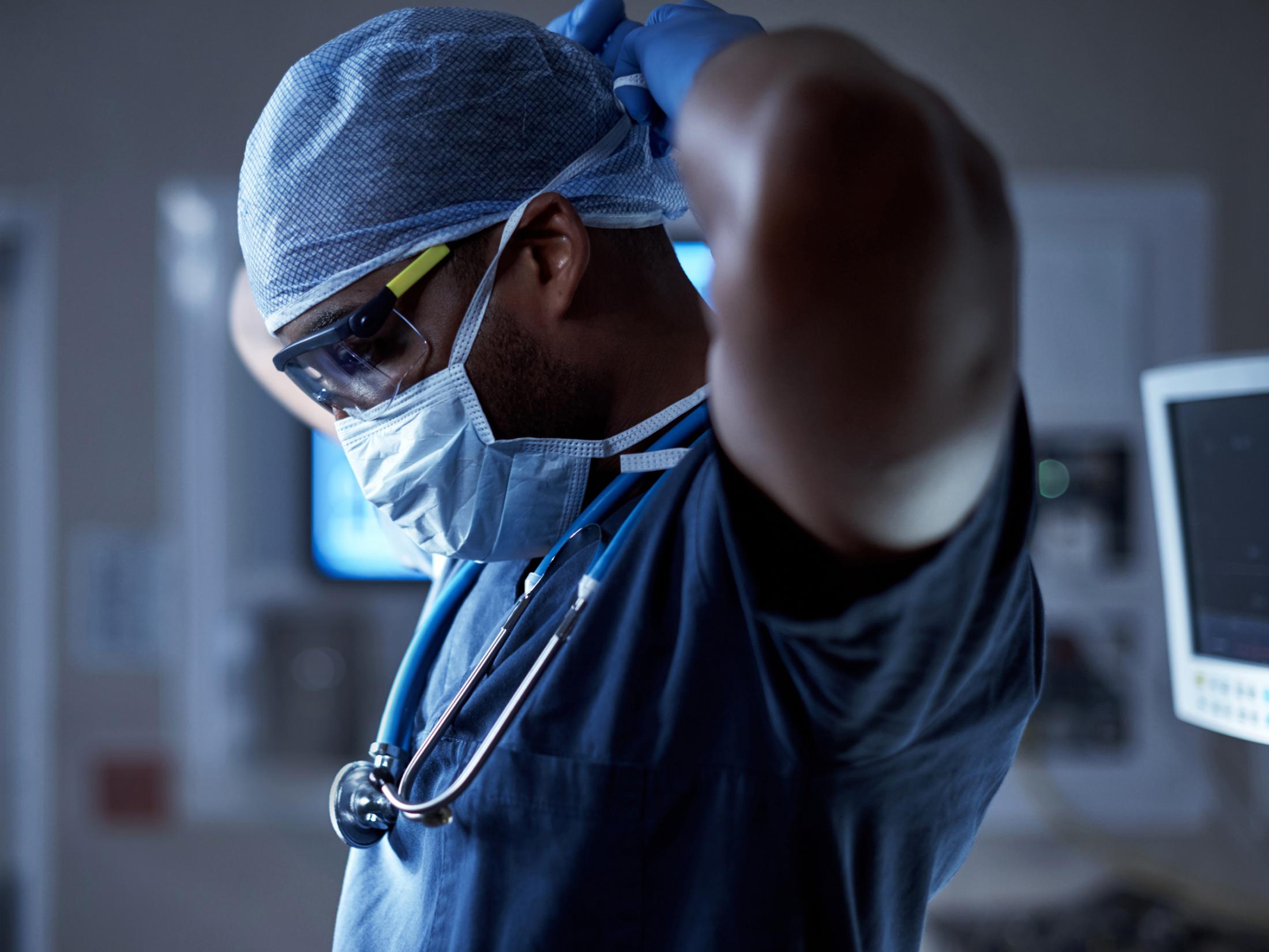 medical professional putting on mask
